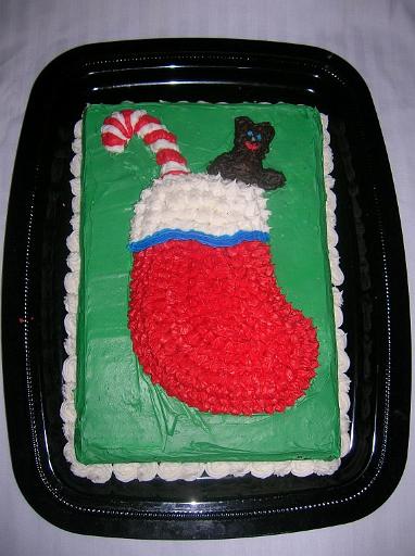 Stocking Cake.JPG - For Christmas, make a stocking cake. Press a 3/4-inch layer of clay into the bottom of a 13x9-inch pan. Scoop out a portion in the center for the stocking. You can also form stocking-stuffer shapes at the top of the stocking or you can add those using icing or decorating clay. Spray the pan and clay with cooking spray, and add cake batter until the cake batter rises about 3/4-inch above the highest part of the clay. Bake until done, loosen the cake from the sides of the pan, and invert the pan. The stocking cake can be decorated using a star decorating tip.Added by: Admin.